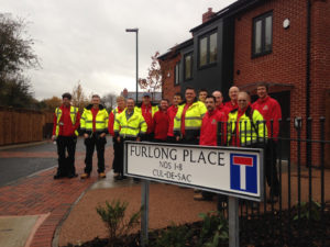 The site team in front of the new homes