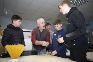 Pupils learning construction skills with Alex Rennie from Robertson Northern