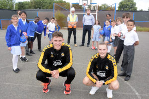 Local school children challenge Cambridge United players to keepy uppies at St Albans Rec