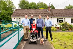 People standing outside a house in Haltwhistle