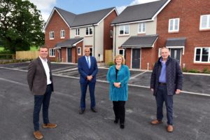 people in front of housing development